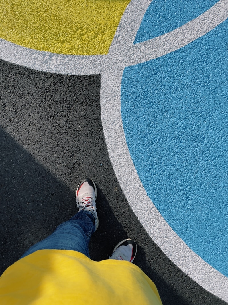 a person's legs and feet on a blue and white carpet